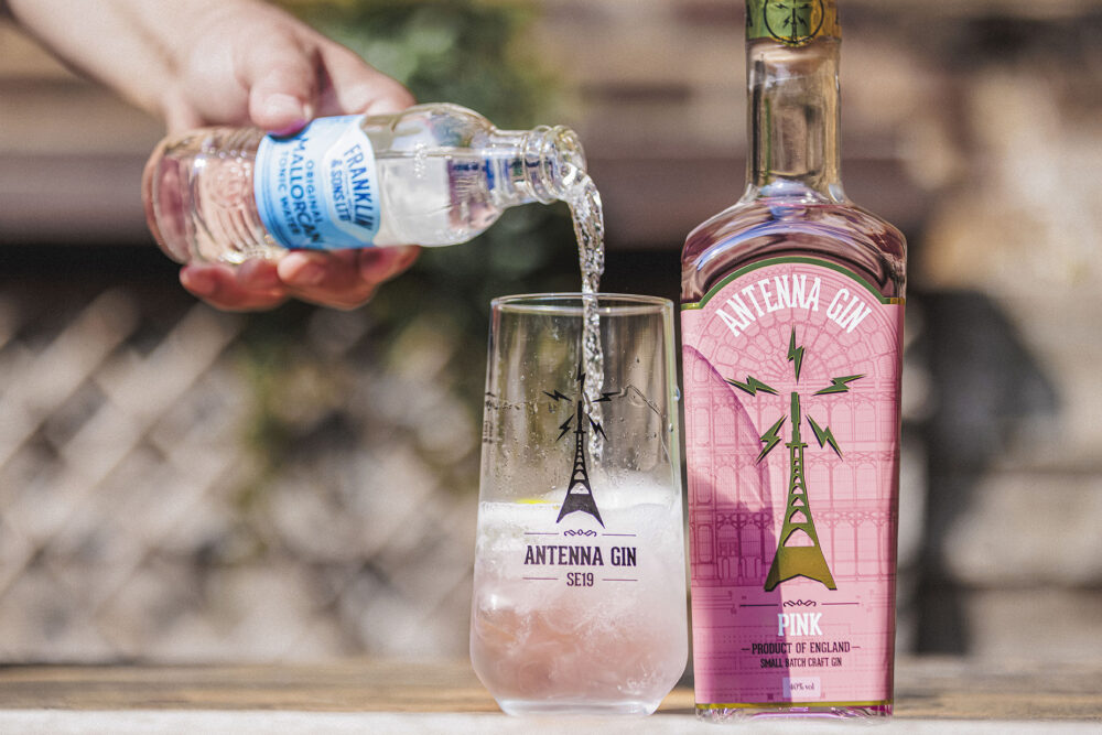 Antenna Pink Gin 700ml being served in Antenna branded glass.