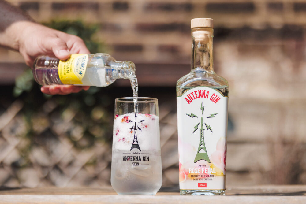 Antenna Rose Gin 700ml being served in Antenna branded glass.